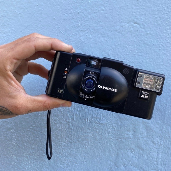 Front Of An Olympus XA2 Film Camera With Flash On